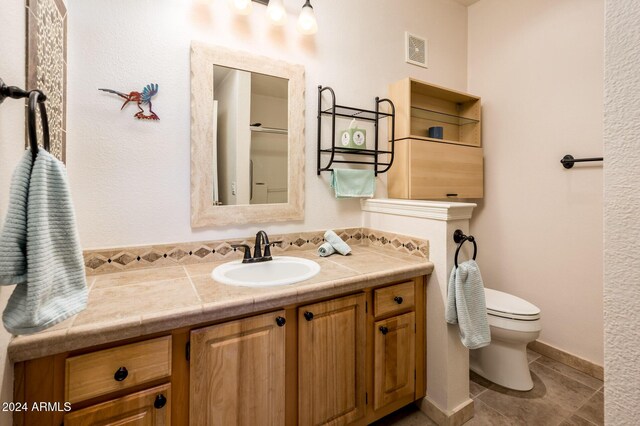 14950 W Mountain View Blvd Unit 1305, Surprise, AZ 85374 - bathroom featuring toilet, vanity, and tile patterned flooring