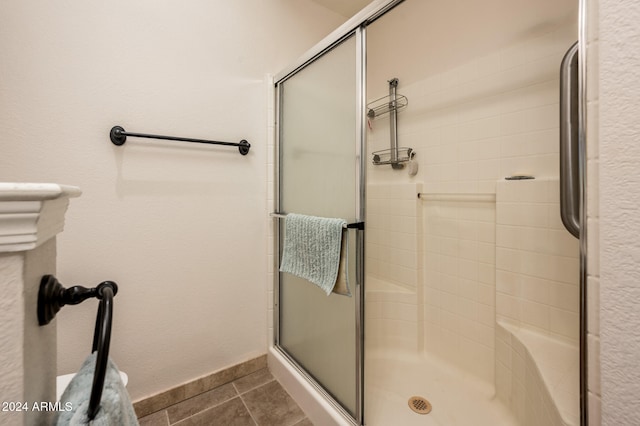 bathroom with tile patterned flooring and walk in shower