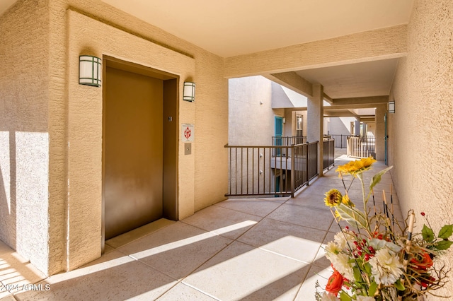 view of exterior entry with a balcony