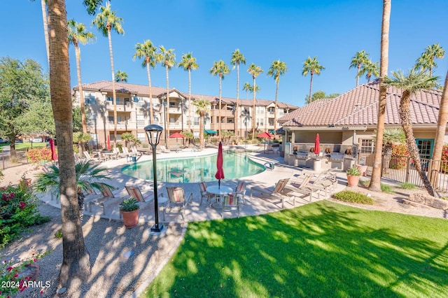 view of pool with a patio area and a yard