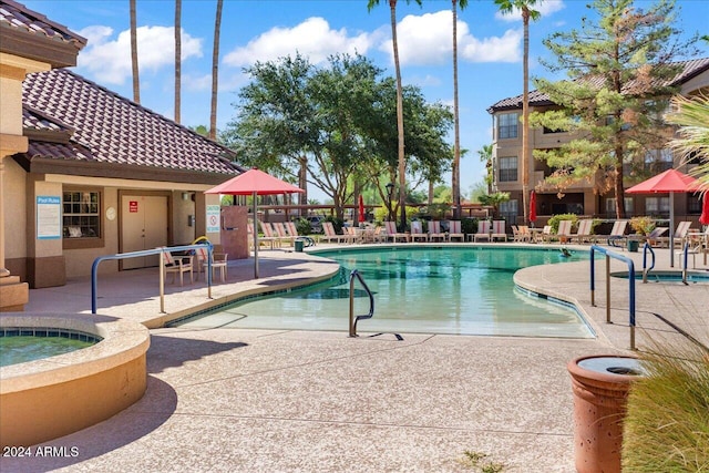 view of pool featuring a patio and a hot tub