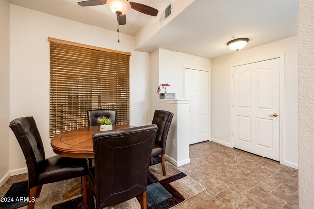 14950 W Mountain View Blvd Unit 1305, Surprise, AZ 85374 - dining area featuring a ceiling fan, stone finish floors, and baseboards