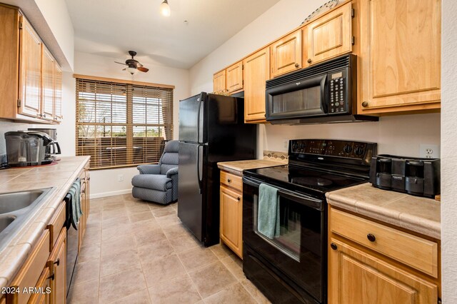 14950 W Mountain View Blvd Unit 1305, Surprise, AZ 85374 - kitchen featuring black appliances, tile countertops, a ceiling fan, light brown cabinets, and light tile patterned flooring