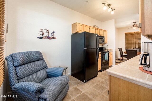 14950 W Mountain View Blvd Unit 1305, Surprise, AZ 85374 - kitchen with black appliances, light brown cabinetry, ceiling fan, open floor plan, and baseboards