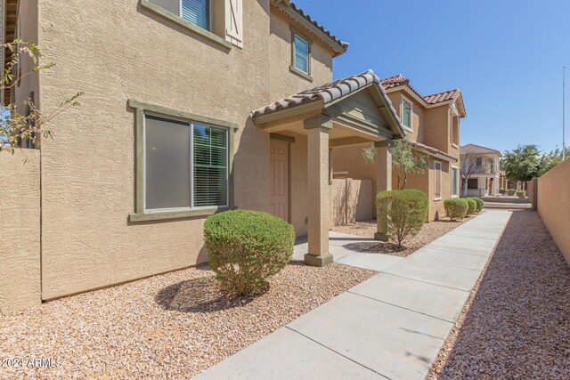 812 E Agua Fria Ln, Avondale, AZ 85323 - property entrance with a residential view, a tile roof, stucco siding, and fence