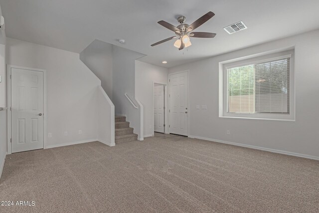 812 E Agua Fria Ln, Avondale, AZ 85323 - unfurnished living room featuring carpet flooring, visible vents, baseboards, and ceiling fan