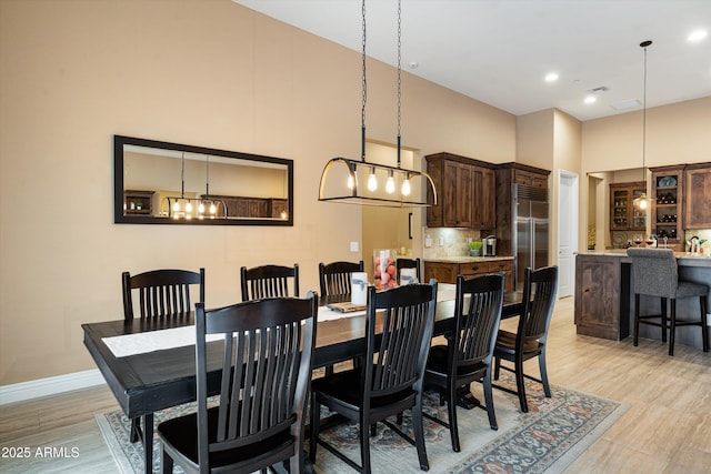 35971 N Prickley Pear Rd, Cave Creek, AZ 85331 - dining space featuring a high ceiling, baseboards, light wood-style flooring, and recessed lighting