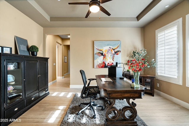 35971 N Prickley Pear Rd, Cave Creek, AZ 85331 - home office featuring a ceiling fan, light wood-type flooring, a tray ceiling, and baseboards
