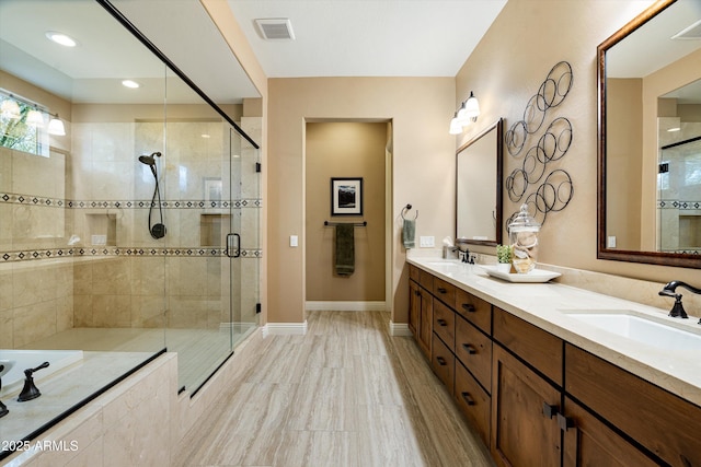 35971 N Prickley Pear Rd, Cave Creek, AZ 85331 - bathroom featuring a shower stall, a bath, double vanity, and baseboards