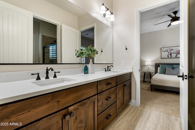 35971 N Prickley Pear Rd, Cave Creek, AZ 85331 - bathroom featuring double vanity, ceiling fan, connected bathroom, a shower with door, and wood finished floors