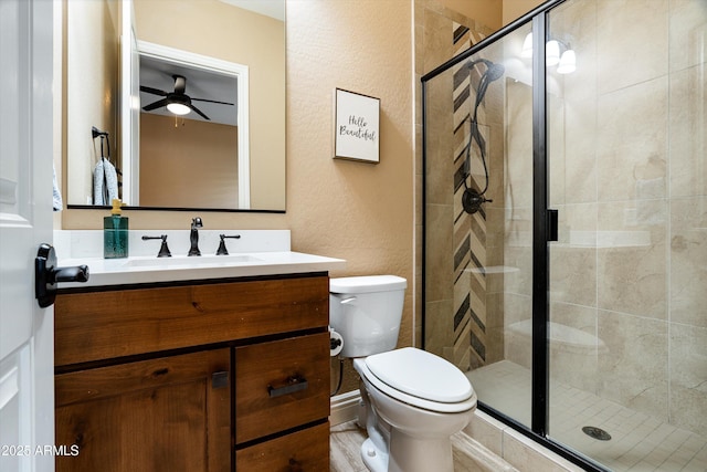 35971 N Prickley Pear Rd, Cave Creek, AZ 85331 - bathroom featuring a stall shower, a textured wall, toilet, a ceiling fan, and vanity