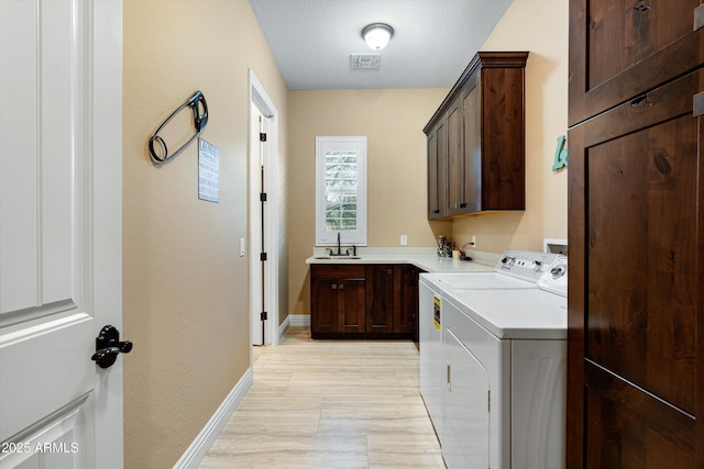 35971 N Prickley Pear Rd, Cave Creek, AZ 85331 - clothes washing area featuring washer and clothes dryer, cabinet space, and baseboards