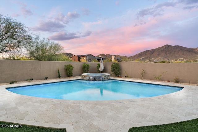 35971 N Prickley Pear Rd, Cave Creek, AZ 85331 - pool at dusk with a fenced backyard, a pool with connected hot tub, a mountain view, and a patio