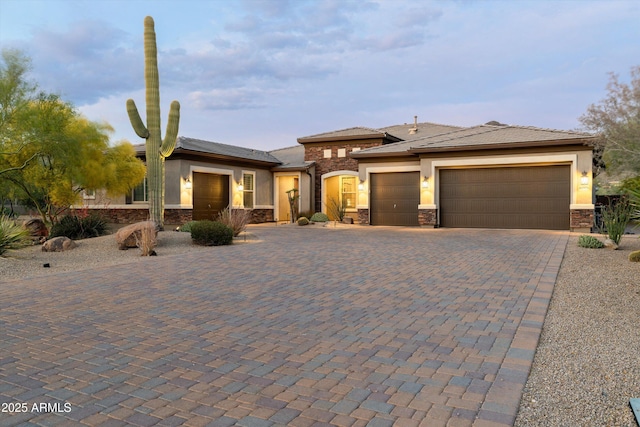35971 N Prickley Pear Rd, Cave Creek, AZ 85331 - prairie-style home with stone siding, a garage, decorative driveway, and stucco siding