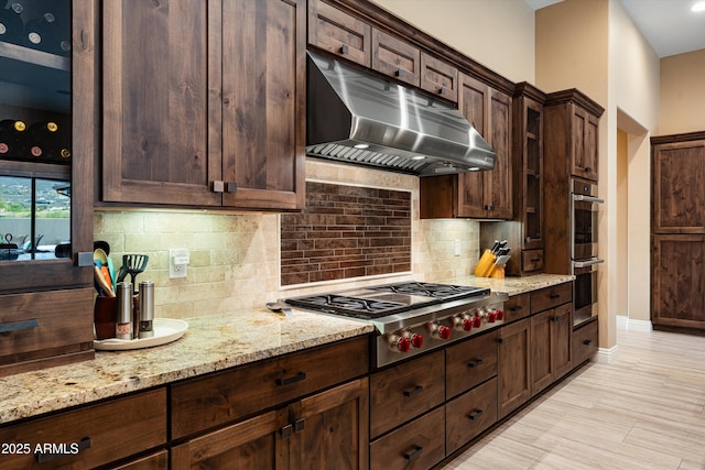 35971 N Prickley Pear Rd, Cave Creek, AZ 85331 - kitchen featuring under cabinet range hood, stainless steel appliances, light stone countertops, and dark brown cabinetry