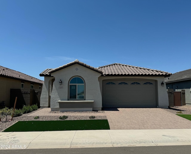 3375 W Verde River Rd, San Tan Valley, AZ 85144 - mediterranean / spanish-style home featuring an attached garage, decorative driveway, stucco siding, and a tiled roof