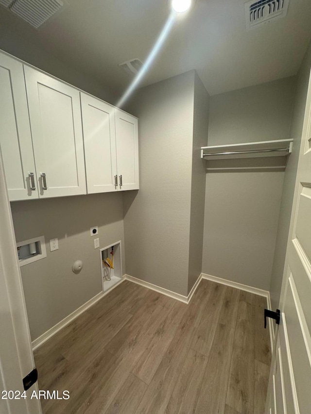 3375 W Verde River Rd, San Tan Valley, AZ 85144 - laundry area featuring hookup for an electric dryer, hookup for a washing machine, wood finished floors, cabinet space, and gas dryer hookup