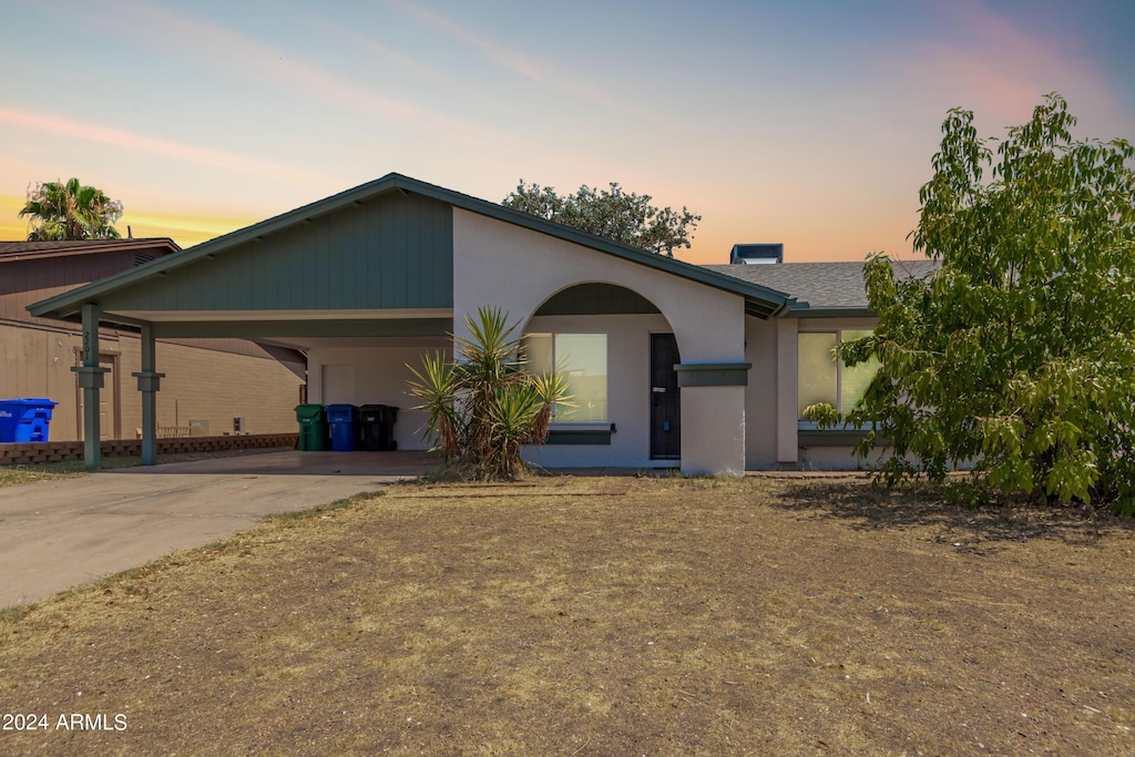 ranch-style house with a carport