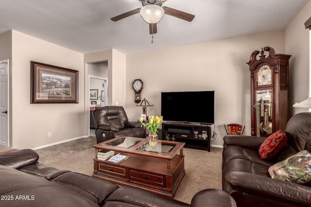 carpeted living room featuring baseboards and a ceiling fan