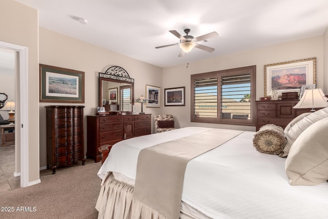 bedroom with a ceiling fan, baseboards, and carpet floors