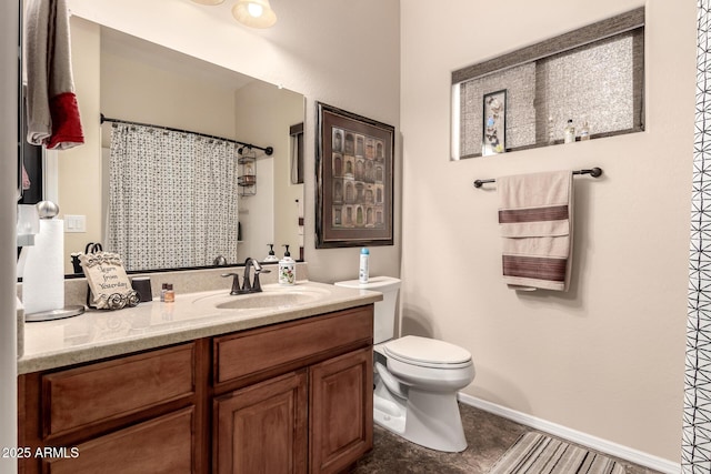 bathroom featuring a shower with shower curtain, baseboards, toilet, and vanity