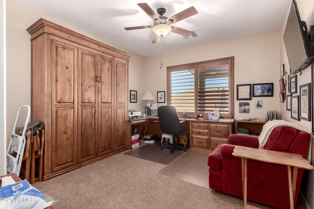 carpeted office space featuring visible vents and ceiling fan