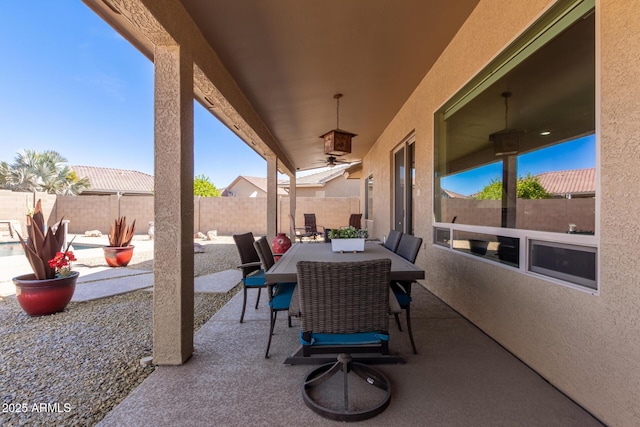 view of patio with outdoor dining area and a fenced backyard