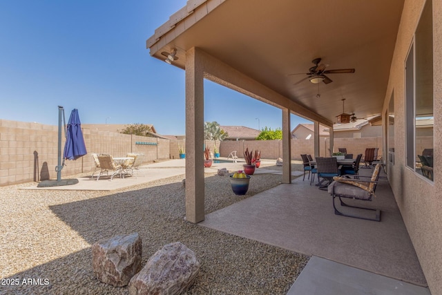 view of patio / terrace featuring a fenced backyard, outdoor dining space, and a ceiling fan