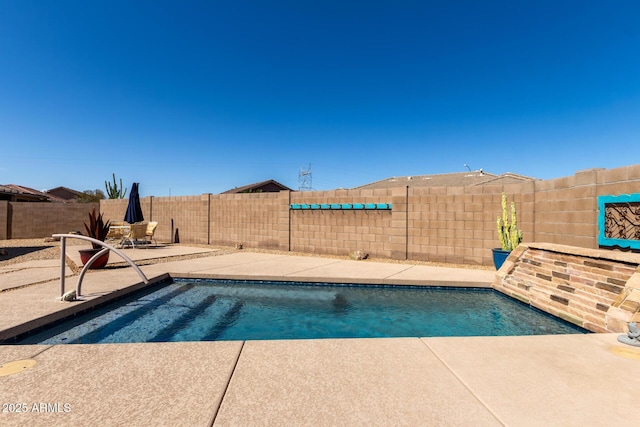 view of pool with a fenced in pool, a patio, and a fenced backyard