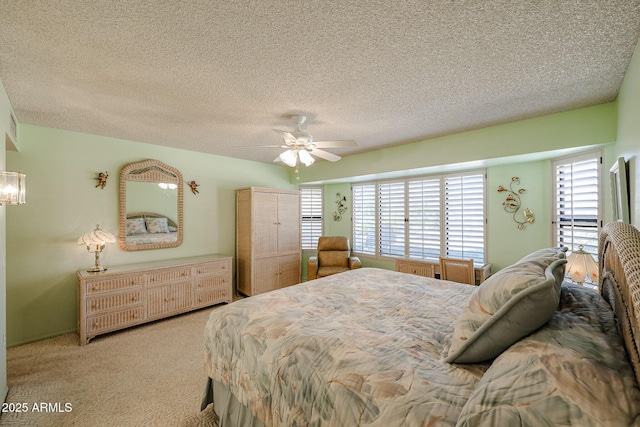 carpeted bedroom with a textured ceiling and ceiling fan