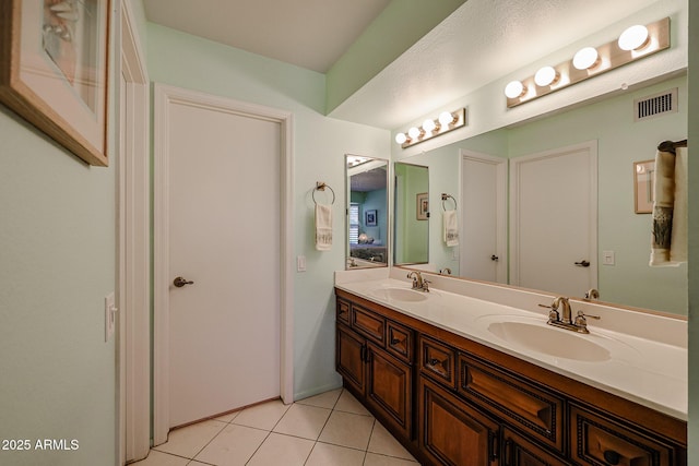 bathroom with tile patterned flooring and vanity