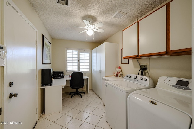 washroom featuring cabinets, a textured ceiling, washer and clothes dryer, ceiling fan, and light tile patterned floors