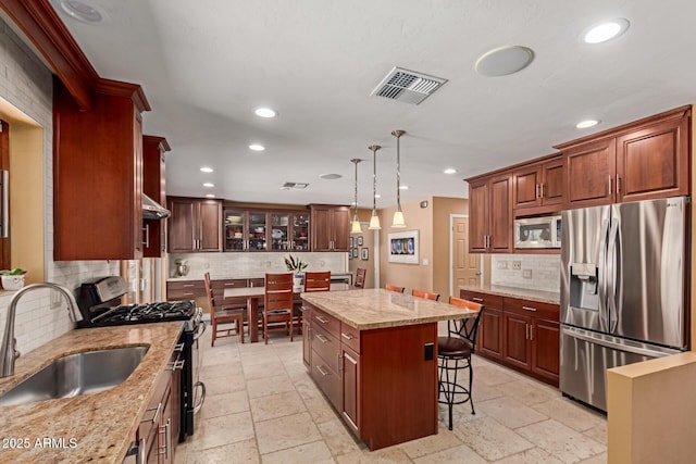 6532 E Aster Dr, Scottsdale, AZ 85254 - kitchen featuring appliances with stainless steel finishes, a sink, tasteful backsplash, recessed lighting, and stone tile flooring