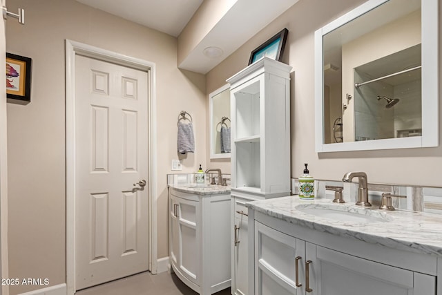 6532 E Aster Dr, Scottsdale, AZ 85254 - bathroom featuring two vanities, a shower, and tile patterned flooring
