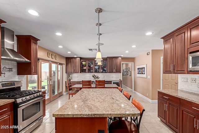 6532 E Aster Dr, Scottsdale, AZ 85254 - kitchen featuring appliances with stainless steel finishes, wall chimney exhaust hood, backsplash, french doors, and recessed lighting