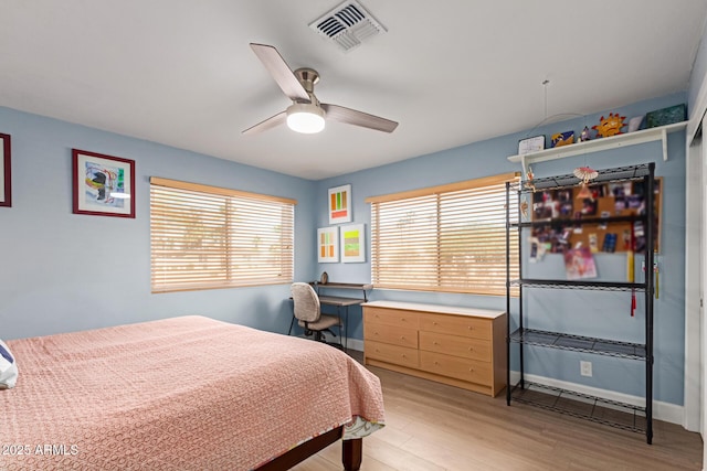 6532 E Aster Dr, Scottsdale, AZ 85254 - bedroom featuring light wood-style flooring, a desk, ceiling fan, and baseboards