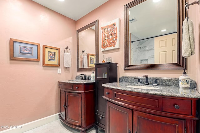 6532 E Aster Dr, Scottsdale, AZ 85254 - full bathroom with two vanities, a shower, baseboards, and recessed lighting