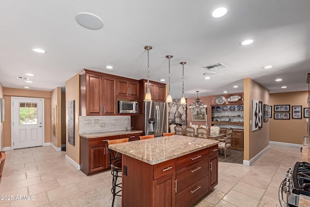 6532 E Aster Dr, Scottsdale, AZ 85254 - kitchen with stainless steel appliances, baseboards, a chandelier, decorative backsplash, and recessed lighting