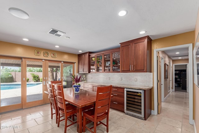 6532 E Aster Dr, Scottsdale, AZ 85254 - dining room with beverage cooler, french doors, healthy amount of natural light, and recessed lighting