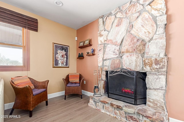 6532 E Aster Dr, Scottsdale, AZ 85254 - sitting room with wood finished floors, baseboards, and a stone fireplace