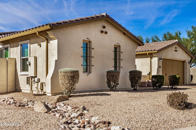 view of side of home with a garage