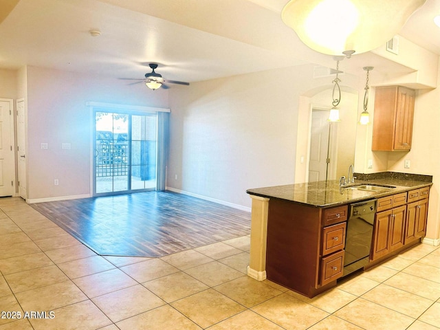 kitchen with hanging light fixtures, light tile patterned flooring, black dishwasher, and sink