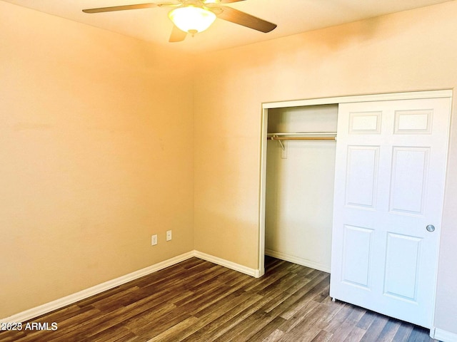 unfurnished bedroom featuring ceiling fan, dark hardwood / wood-style flooring, and a closet