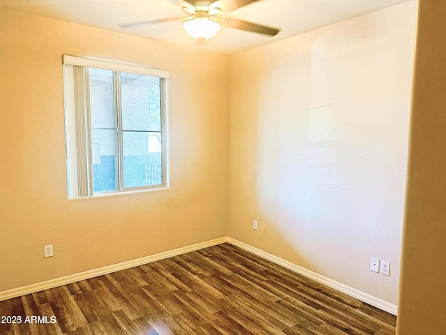 spare room featuring dark hardwood / wood-style floors and ceiling fan