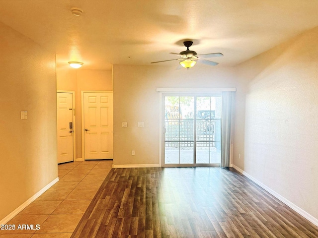 spare room featuring wood-type flooring and ceiling fan