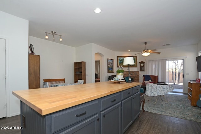 7604 E Sedalia Trl, Prescott Valley, AZ 86315 - kitchen featuring wooden counters, a center island, dark hardwood / wood-style floors, gray cabinets, and ceiling fan