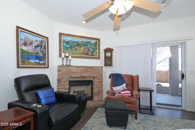 7604 E Sedalia Trl, Prescott Valley, AZ 86315 - living room with a stone fireplace, dark hardwood / wood-style floors, and ceiling fan
