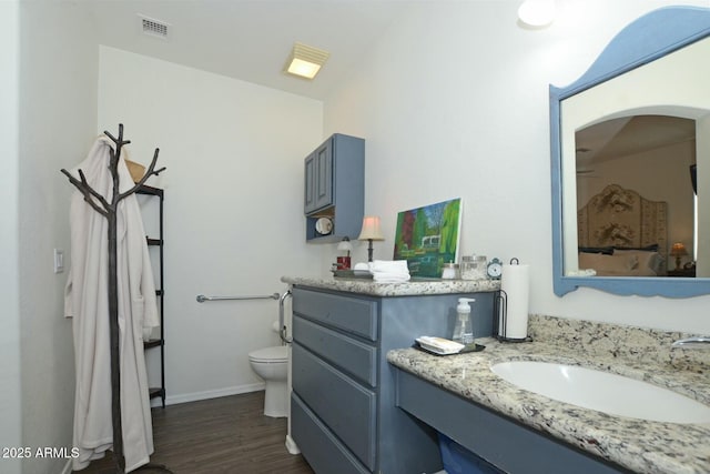 7604 E Sedalia Trl, Prescott Valley, AZ 86315 - bathroom with hardwood / wood-style flooring, vanity, and toilet