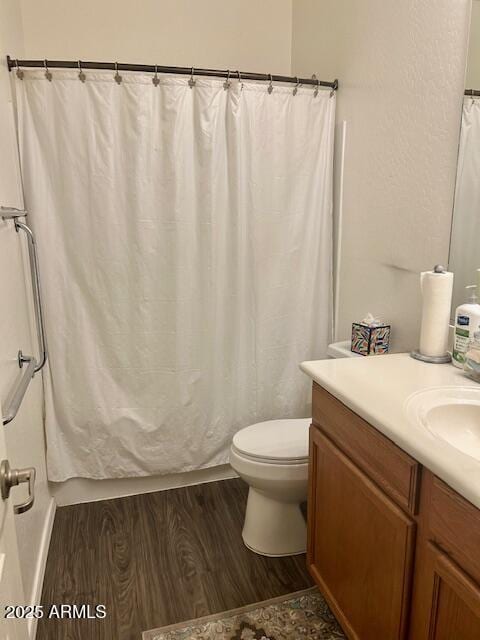 7604 E Sedalia Trl, Prescott Valley, AZ 86315 - bathroom with vanity, hardwood / wood-style floors, and toilet