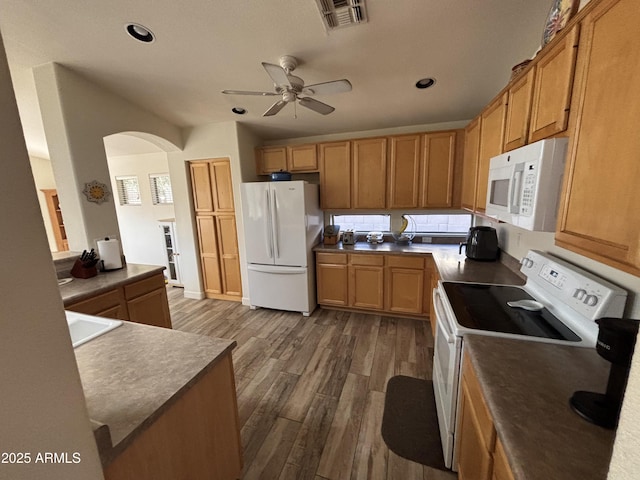 kitchen with ceiling fan, white appliances, and dark hardwood / wood-style flooring